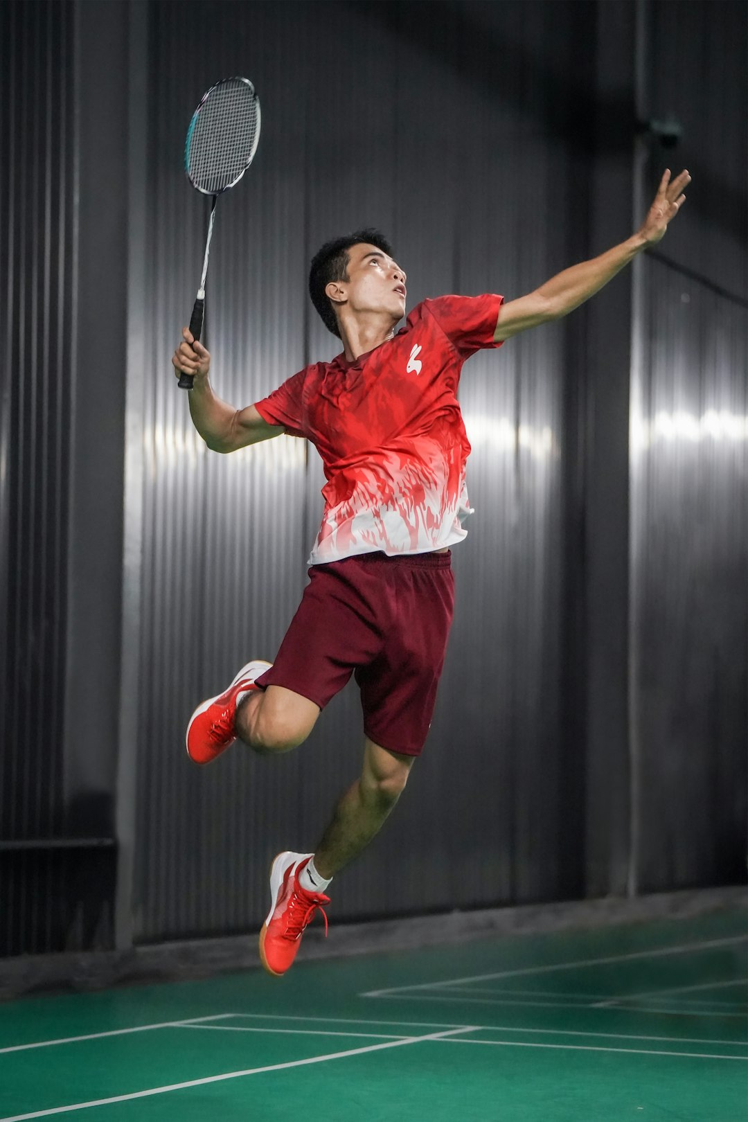 a-man-jumping-in-the-air-with-a-tennis-racket-sxwrpljtuxc